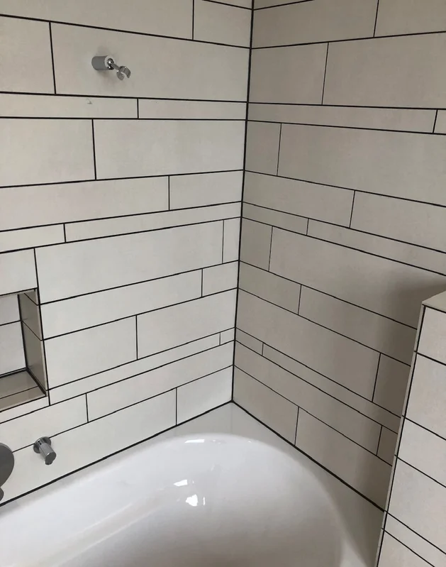 Fugenabdichtung an einer Fliesenwand im Badezimmer in der Ostschweiz